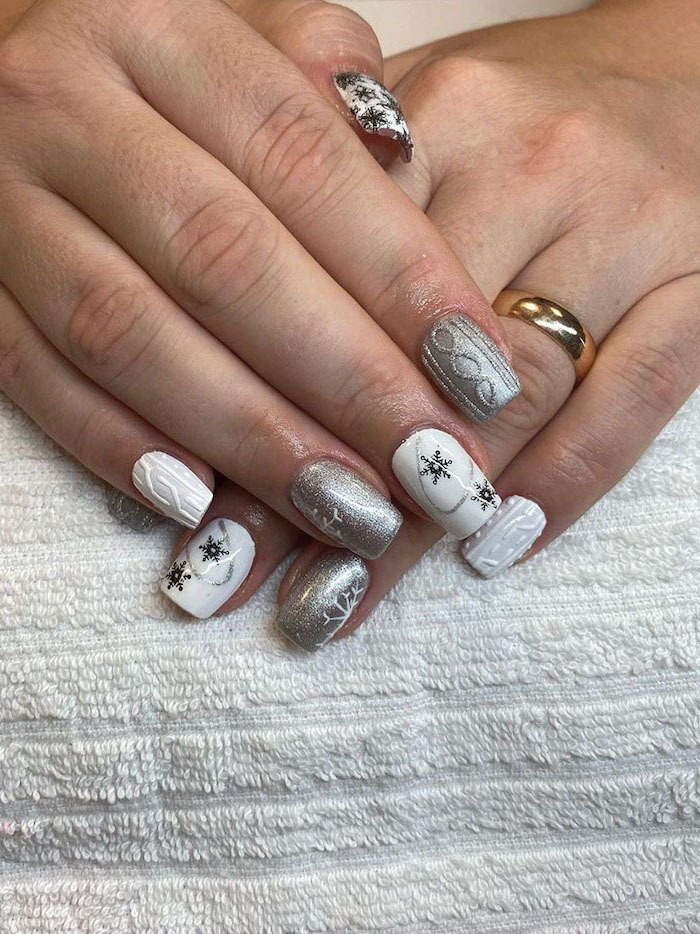 white and silver metallic nail polish, winter nail ideas, short square nails, different decorations on each nail