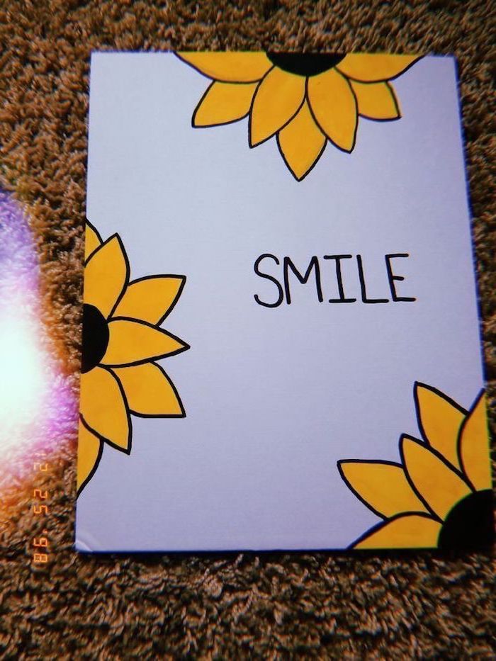 smile written in black on white background, surrounded by yellow sunflowers, cute drawing ideas