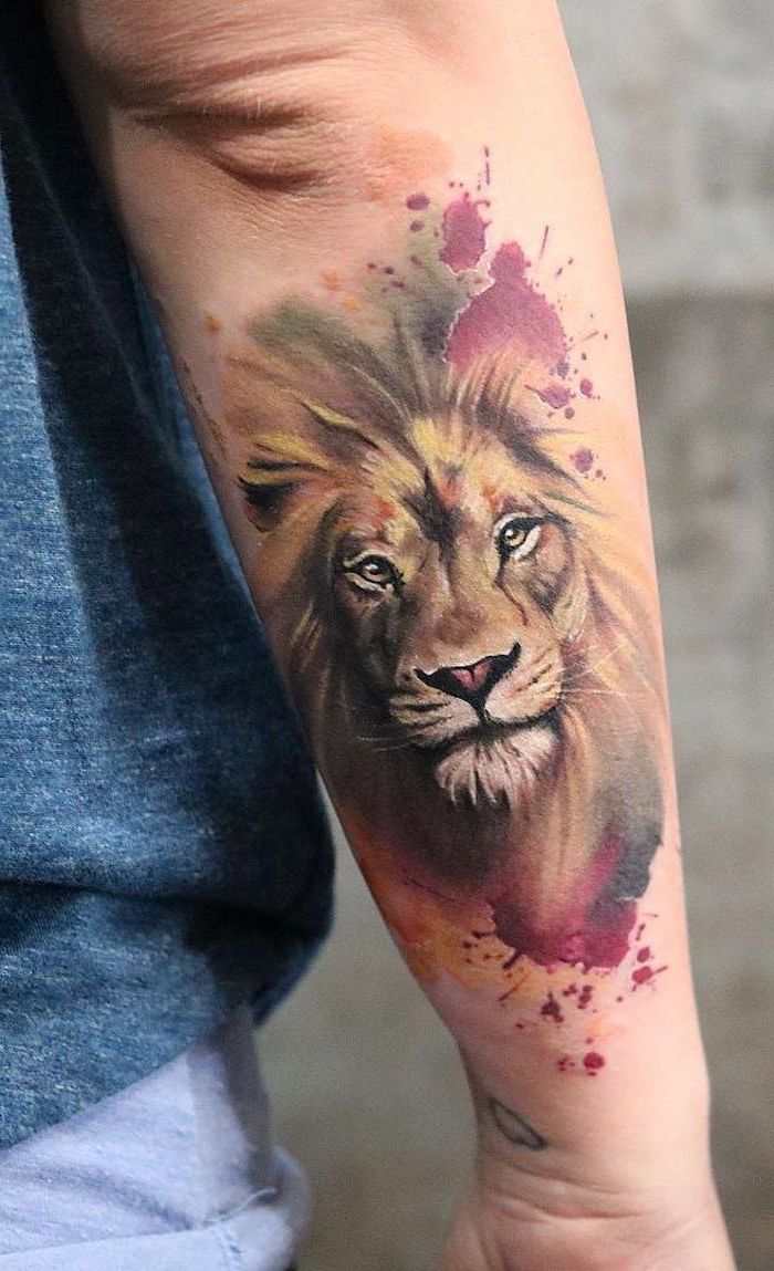 small lion tattoo, watercolor tattoo, back of arm tattoo, lion head, surrounded by watercolor in pink yellow and red