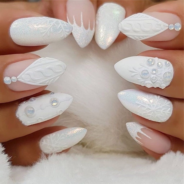 white matte and glitter nail polish, january nail colors, different decorations with rhinestones on each finger