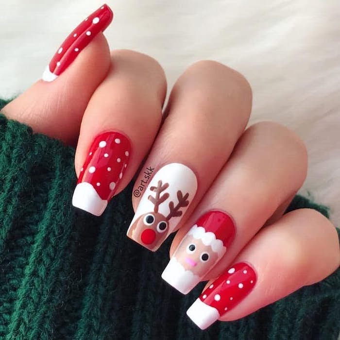 red and white nail polish, santa and reindeer decorations on middle and ring fingers, winter acrylic nails, long square nails