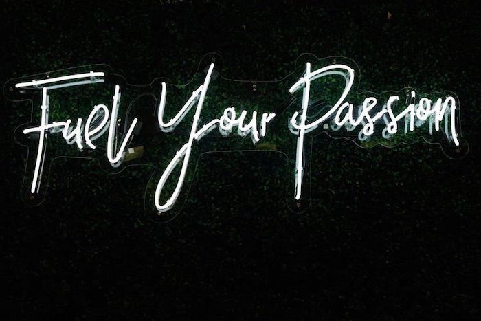 fuel your passion, white neon sign, hanged on greenery wall, aesthetic backgrounds, black background
