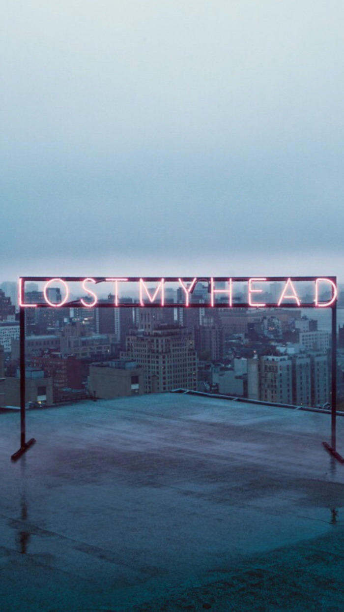 lost my head neon sign, placed on top of a building, dark aesthetic wallpaper, city skyline in the background