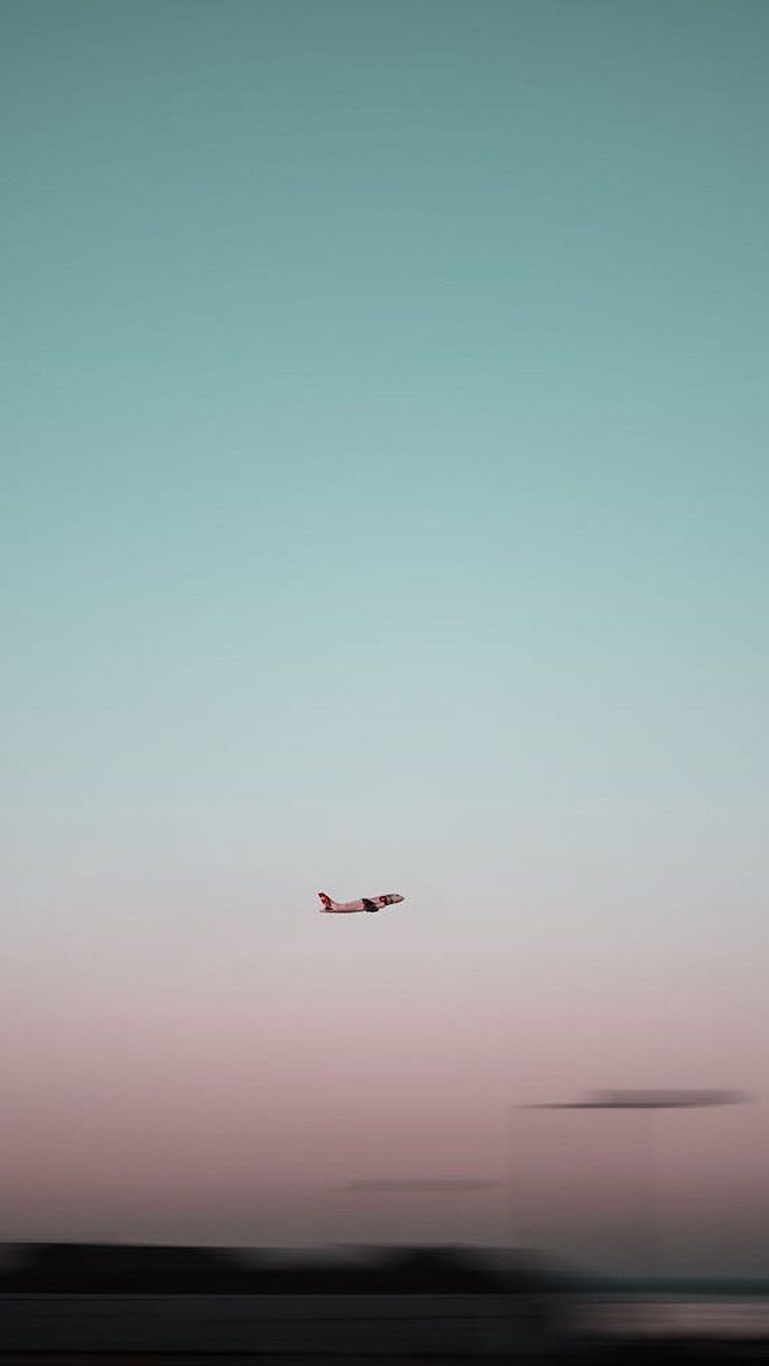 plane flying in the sky, pink aesthetic background, blue and pink sky