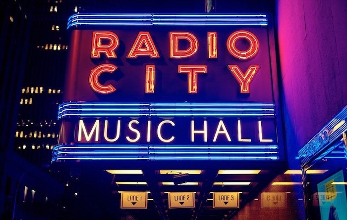 aesthetic phone backgrounds, radio city music hall neon sign, on the side of the entrance, photographed at night