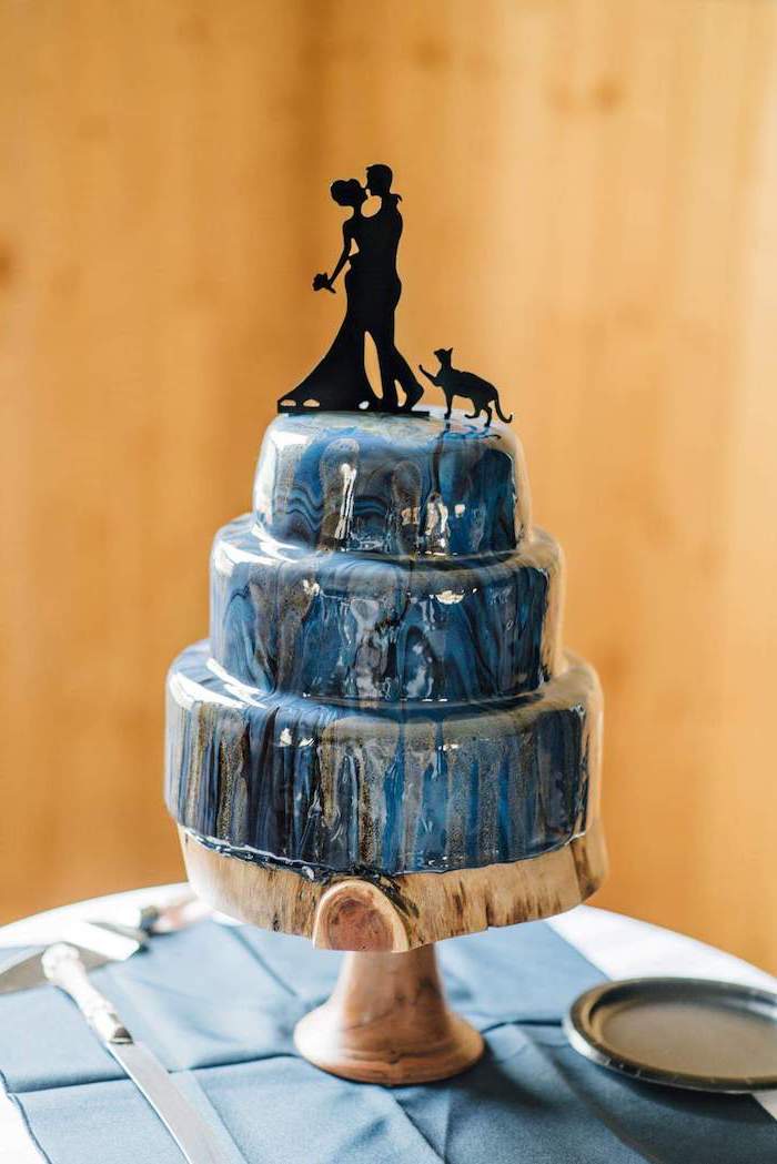 three tier cake, placed on wooden cake stand, galaxy cake, blue and grey mirror glaze, wedding cake