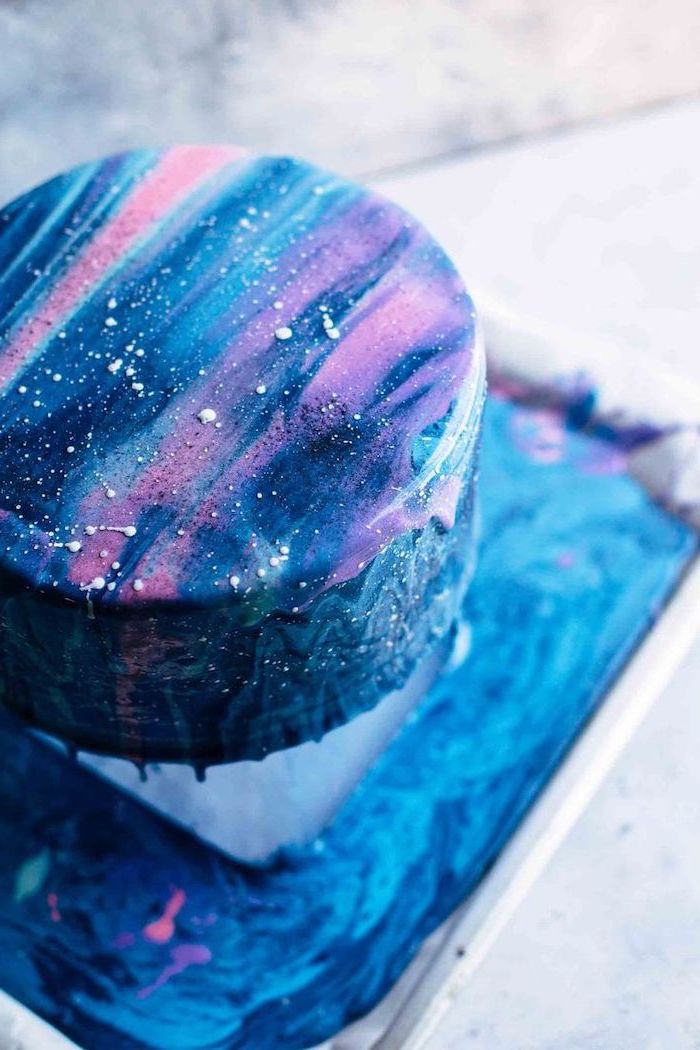 one tier galaxy cake, cake glaze recipe, covered with blue purple and pink glaze, placed on a metal cake stand