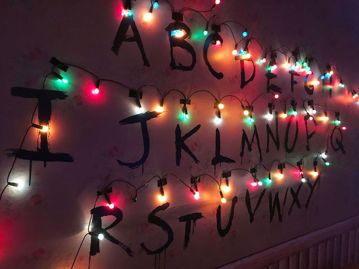 joyce byers alphabet wall, stranger things wallpaper iphone x, alphabet written on the wall, surrounded by colorful christmas lights